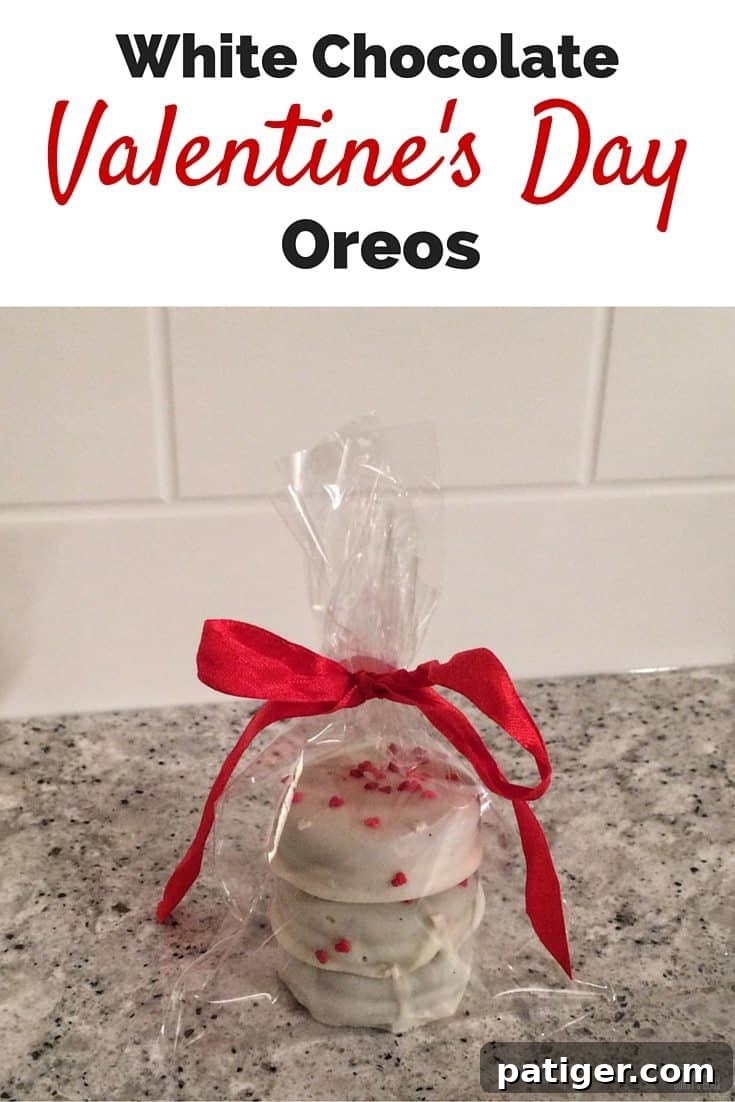 Love-Dipped White Chocolate Oreos 7 A close-up of a platter of white chocolate covered Valentine's Day Oreos, adorned with festive heart sprinkles, ready to be enjoyed.