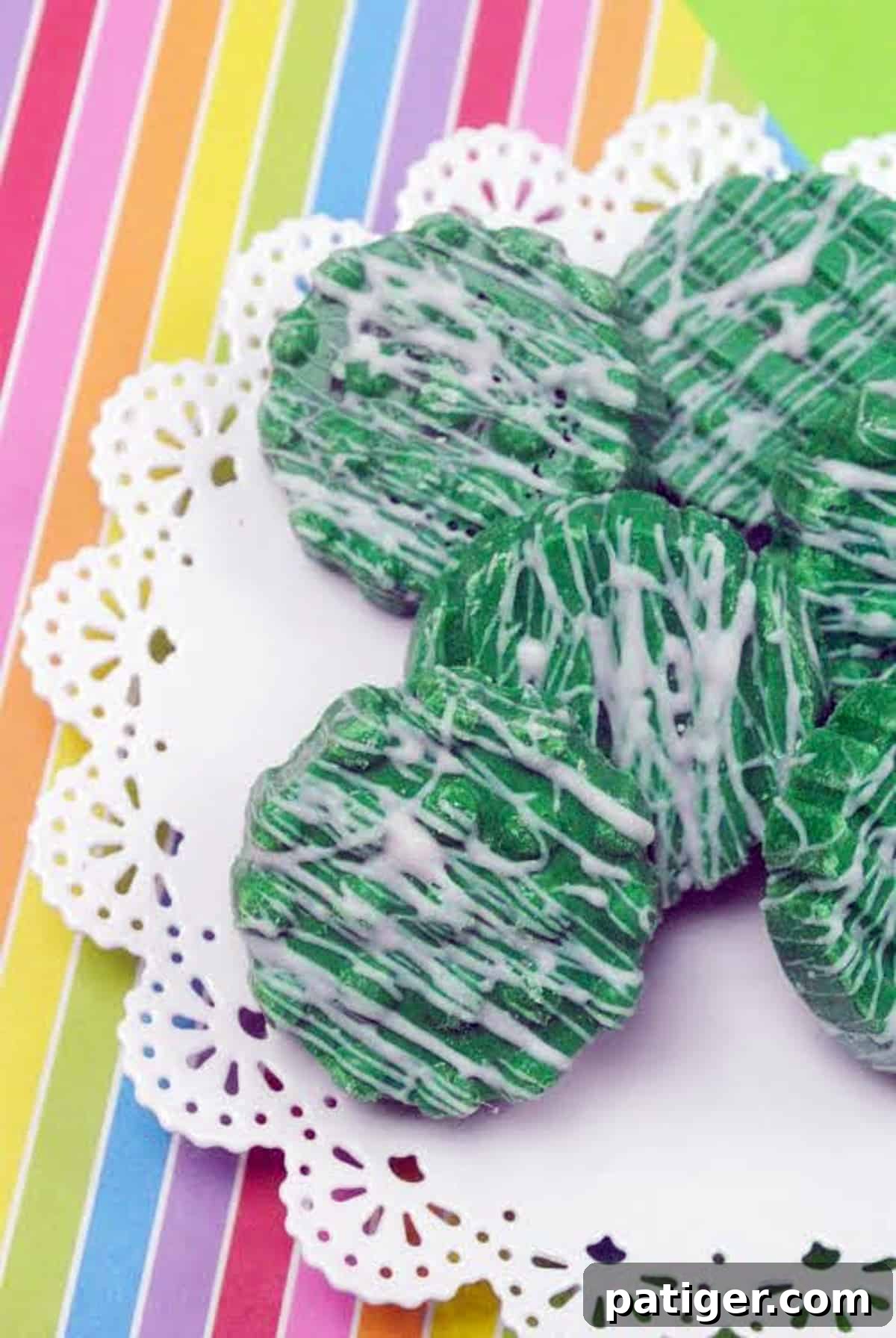 Vibrant green St. Patrick's Day Oreos dipped in chocolate with a delicate white chocolate drizzle, set against a rainbow-themed background, ready for festive celebrations.