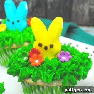 Close-up of a Peeps Easter cupcake, showing the green frosting and marshmallow bunny.