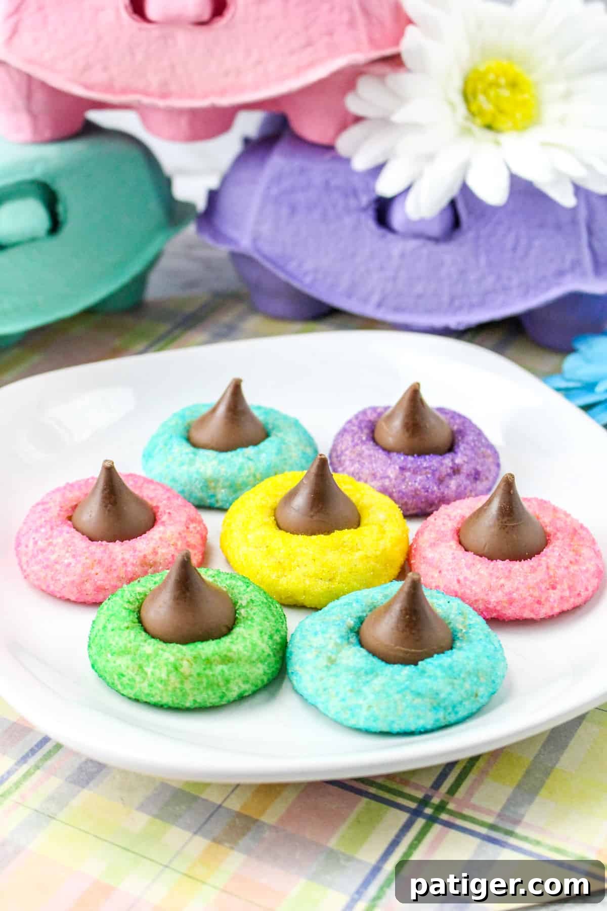 Colorful Easter Blossom Cookies with Hershey Kisses on white plate.