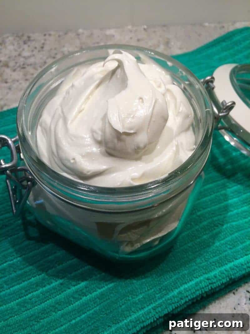 Finished DIY whipped body butter elegantly presented in a clean glass jar, prepared for storage and ready for indulgent use.