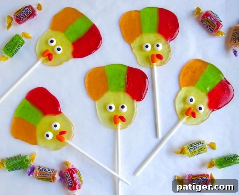 5 Turkey lollipops on white background with jolly rancher candies around them.