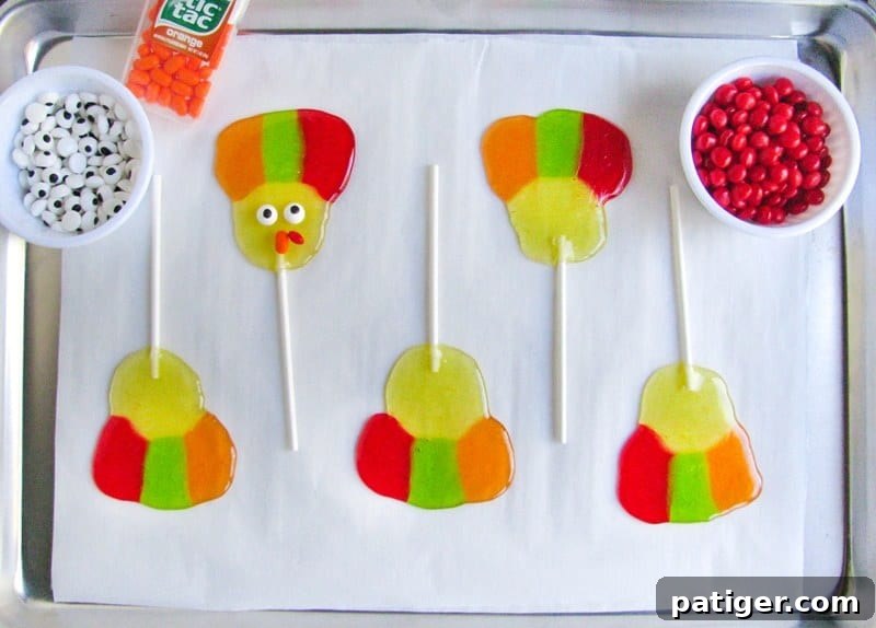 5 turkey lollipops, one has eyeballs and candies added to make the turkey's face.