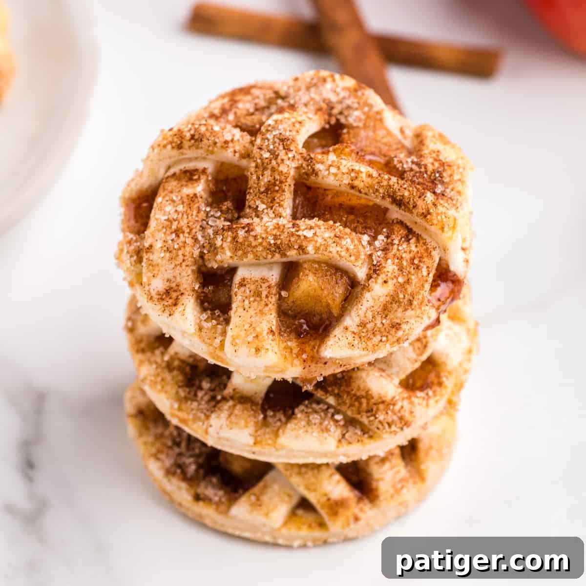 Apple pie cookies stacked on top of one another.