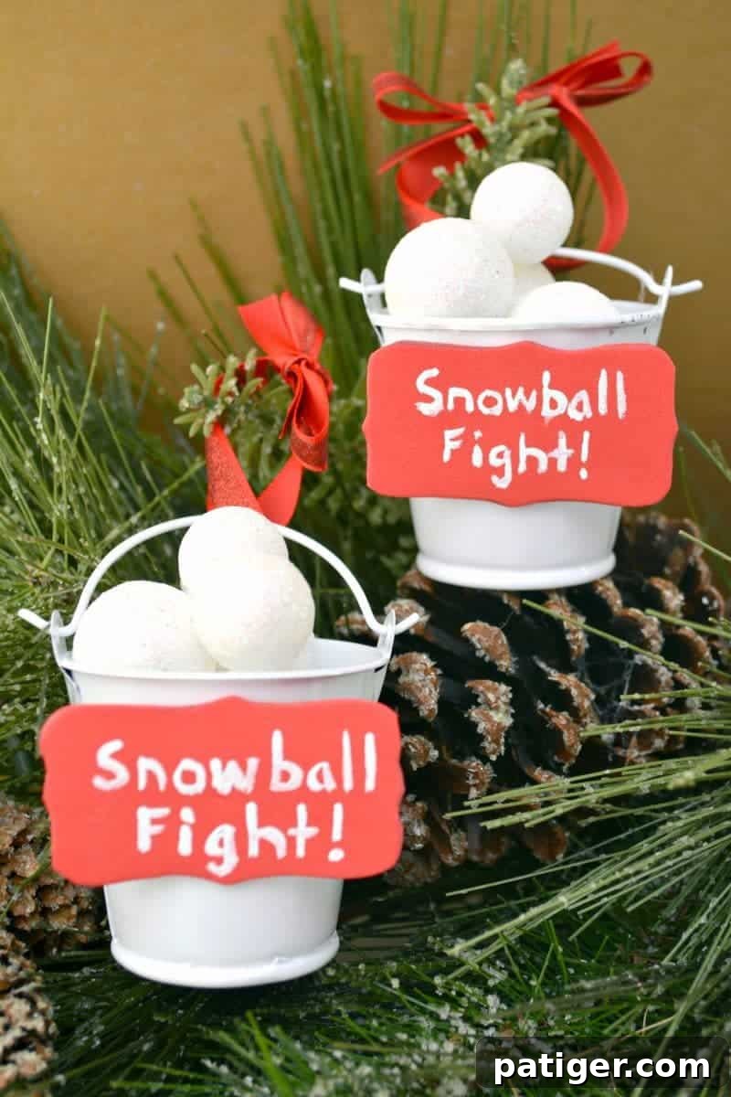 Playful Snowball Fight Christmas ornament featuring miniature buckets of snowballs, perfect for a whimsical tree.