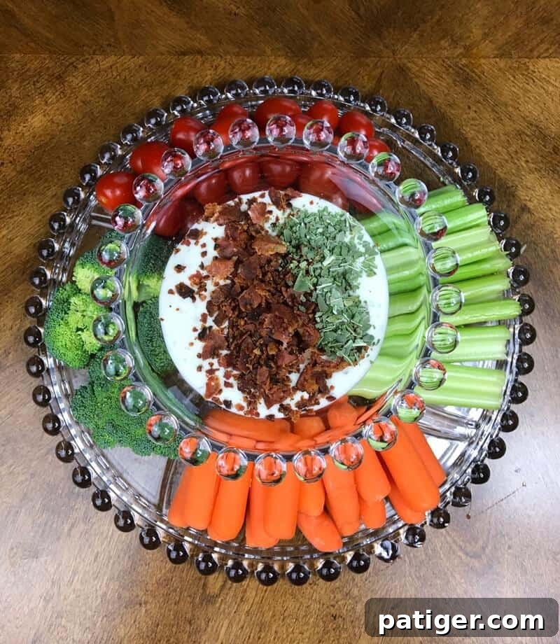 A tantalizing close-up view of creamy ranch dressing in a mixing bowl, generously topped with vibrant green basil and perfectly crumbles of crispy, smoky bacon, showcasing the fresh and savory components of the dip.