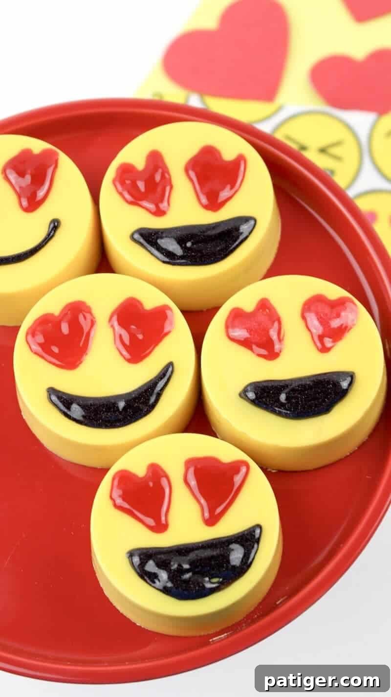 Chocolate covered Oreo cookies decorated to look like heart eyes emojis, arranged beautifully.