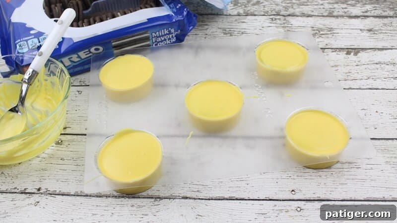Mold filled with 5 perfectly yellow covered oreo cookies, chilled and ready.