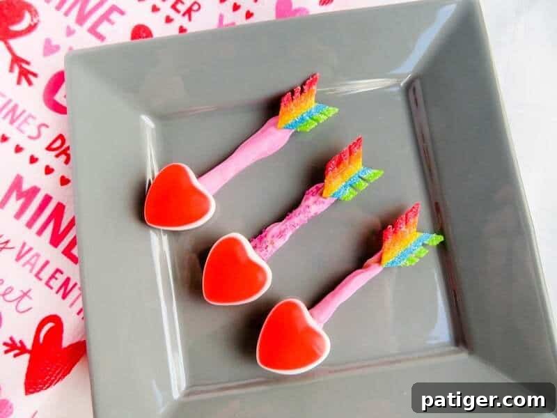 Three candy arrows on gray plate.
