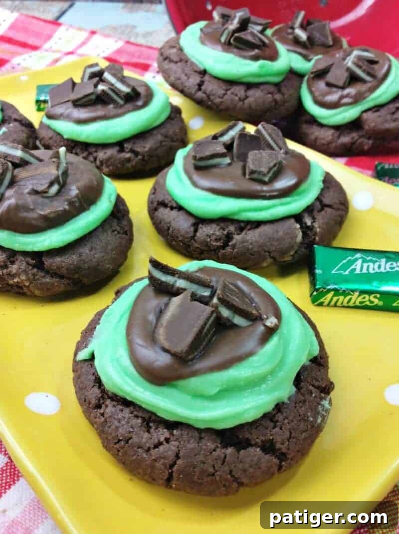 Grasshopper cookies topped with green frosting, melted chocolate, and chopped Andes Mint candies.