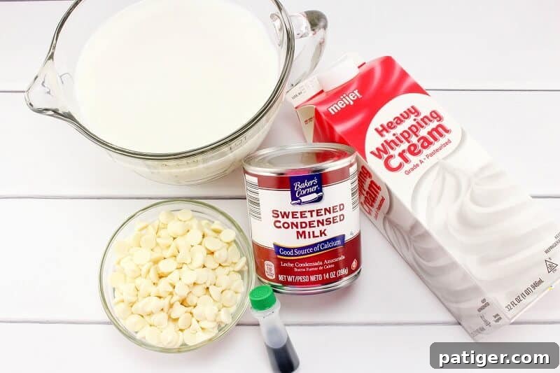 Shamrock Swirl Frozen Hot Chocolate 5 Layout of ingredients for St. Patrick's Day Frozen Hot Chocolate: bottles of milk and heavy whipping cream, a can of sweetened condensed milk, a bowl of white chocolate chips, and a small container of green food coloring.