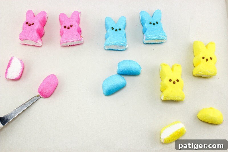 Bottom of peeps marshmallows being cut off so that they will sit flat in the twinkie cars.