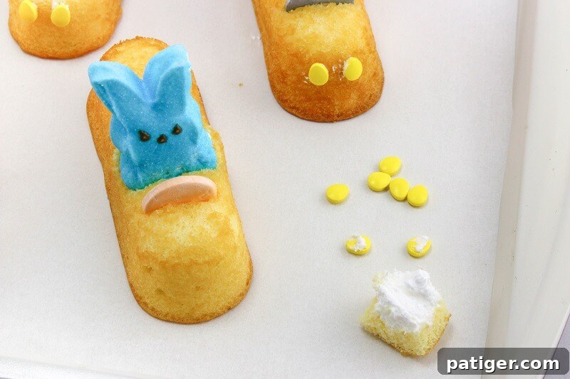 Yellow candies placed on front of Twinkes to form headlights. 