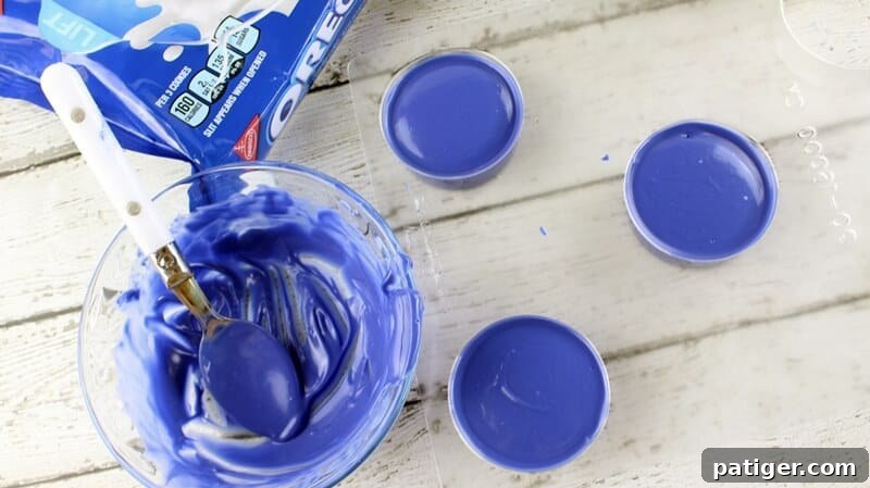 Father's Day Dipped Oreo Delights 6 Melted blue candy completely covers the OREO cookies in the candy mold, creating a smooth, even coating for the Father's Day treats.