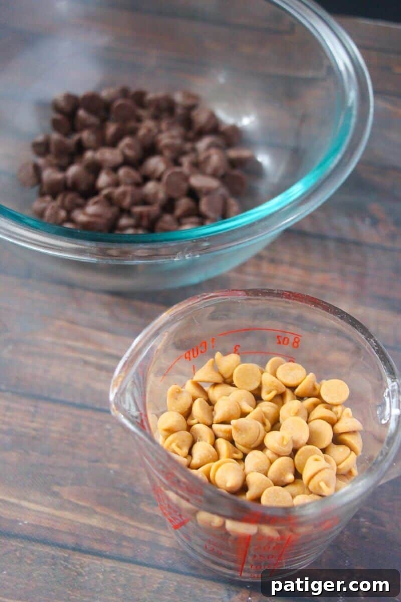 Glass bowl of chocolate chips and glass measuring cup with peanut butter chips, alongside a can of sweetened condensed milk.