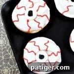 Bloodshot monster eyeball donuts on black plate, ready to be shared.