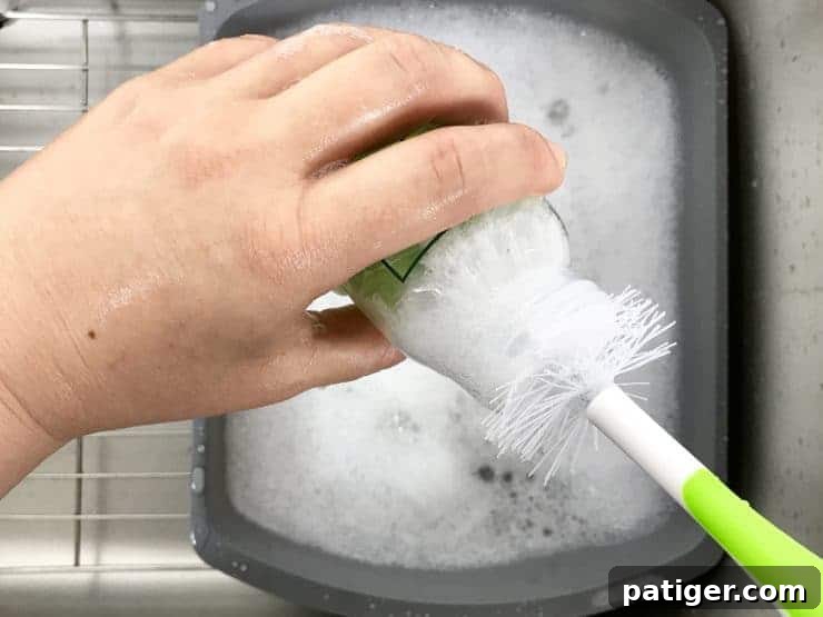 Your 11-Item Bottle Feeding Survival Kit 5 Washing Bottle With Bottle Brush. over dish pan