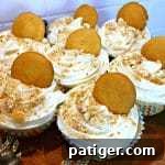 Vanilla Wafer Banana Pudding Cupcakes 9 A close-up of a single banana pudding cupcake on a white plate, showcasing its rich, creamy texture and inviting presentation, ready for a taste test.