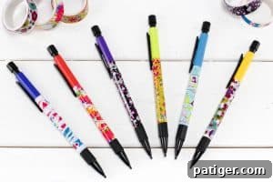 A neat stack of six completed washi tape pencils, showcasing various designs and colors, ready for use.