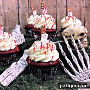 Crimson Confections 5 Bloody cupcakes: Red velvet cupcakes with cream cheese frosting and blood splatter.