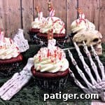 Crimson Confections 6 Bloody cupcakes: Red velvet cupcakes with cream cheese frosting and blood splatter.