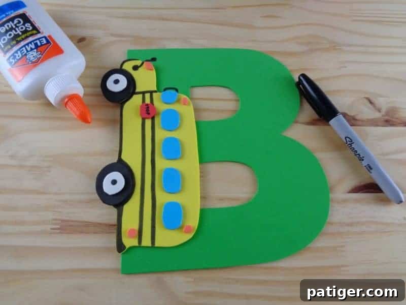 Final assembly steps for the Letter B is for Bus craft, gluing all parts onto the yellow bus body.