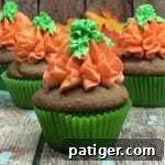 A close-up of a beautifully frosted pumpkin spice cupcake, ready to be enjoyed.