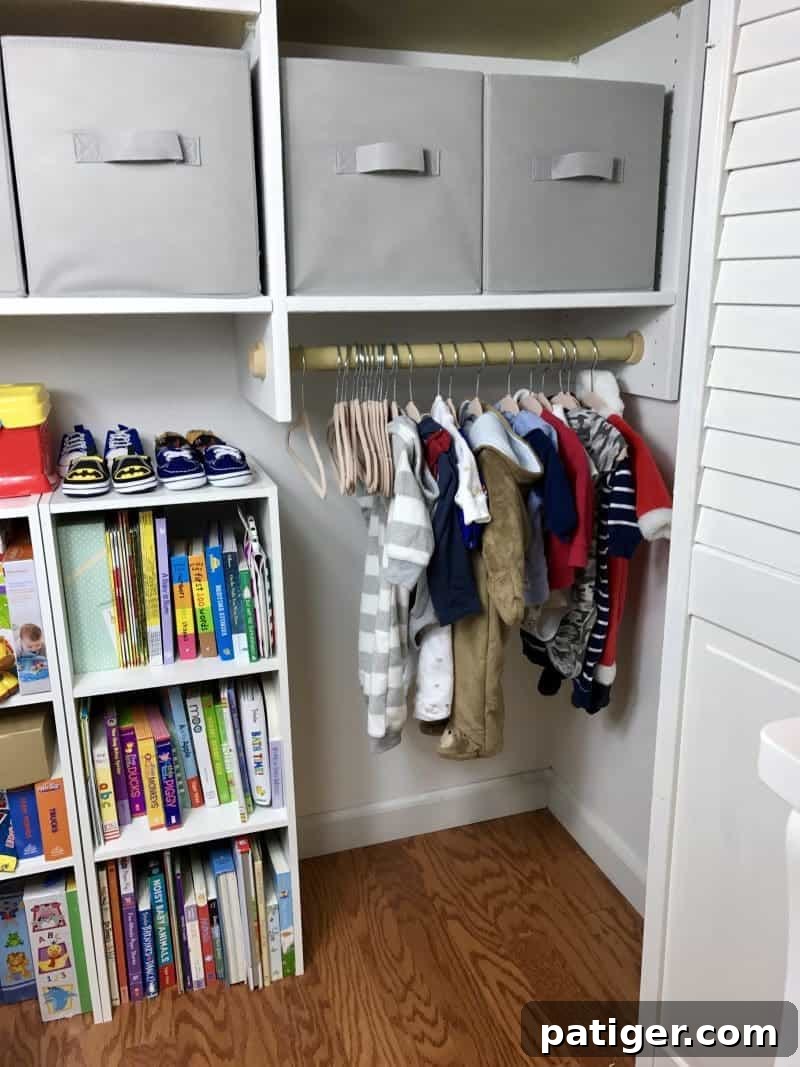 Nursery closet with shelving for storage and low hanging bar for clothing. 