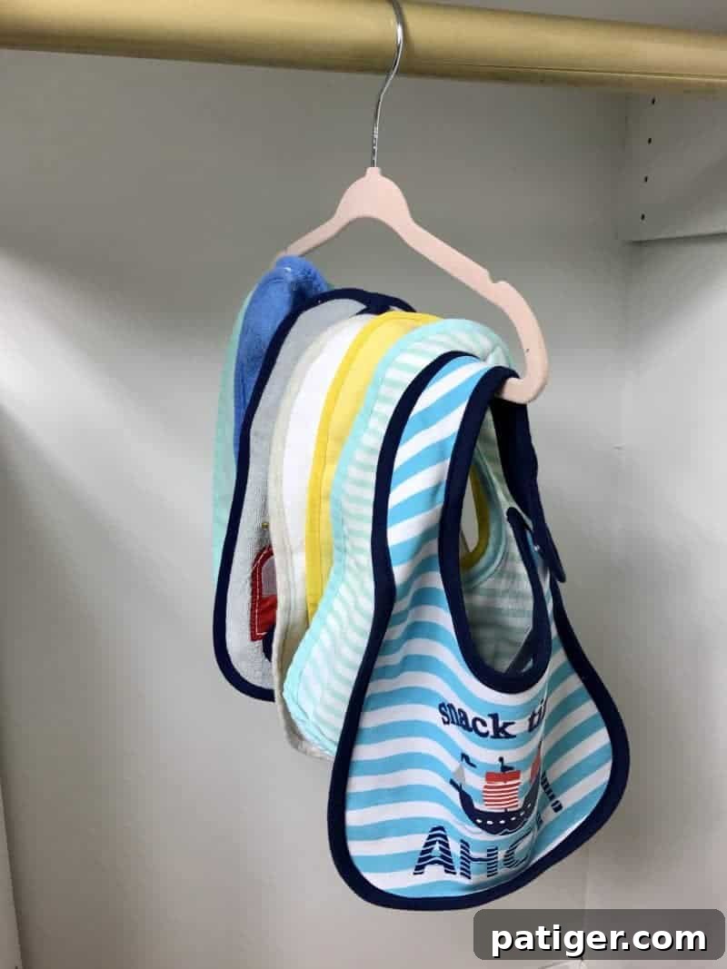 Several baby bibs on hanger.