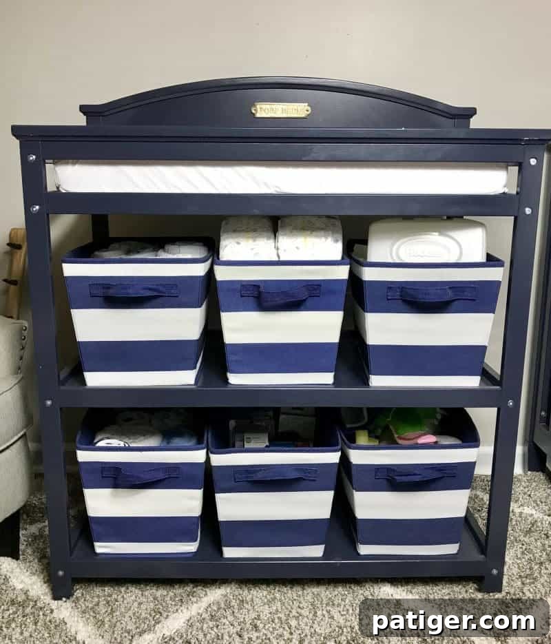 Changing table with changing pad on top and shelves with storage bins for diapers, wipes, etc...