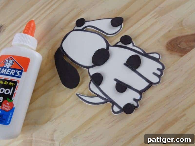 Fun Letter D Dog Craft Printable 9 Step 8: Glue the nose and spots onto the dog's face for the Letter D craft.