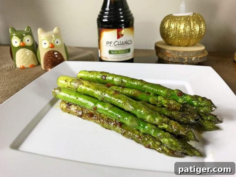 Garlic Soy Seared Asparagus 3 Soy sauce asparagus on white plate.