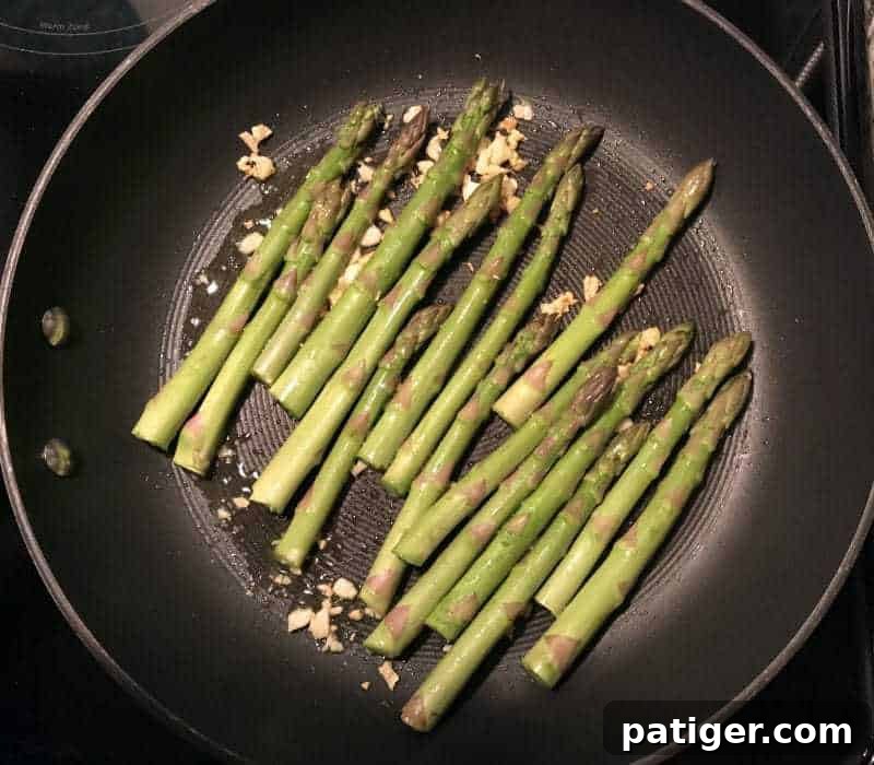 Garlic Soy Seared Asparagus 6 Uncooked asparagus in frying pan.