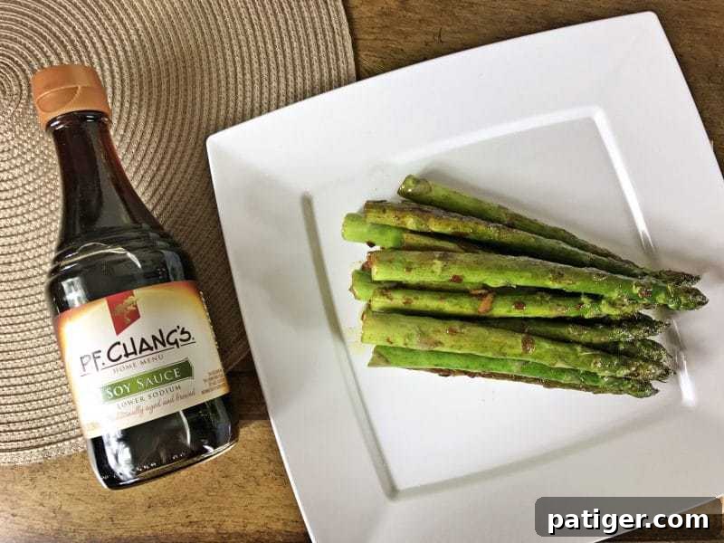 Garlic Soy Seared Asparagus 9 Pan-seared asparagus with bottle of soy sauce.