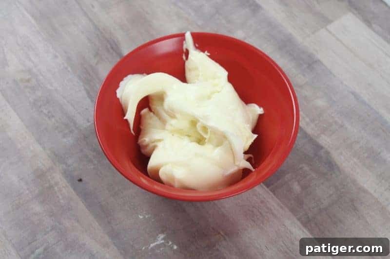 A bowl filled with store-bought vanilla frosting, ready to be colored.