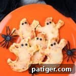 Phantom Pizza Bites 10 Mini Ghost Shaped Pizza with pieces of olives for eyes.