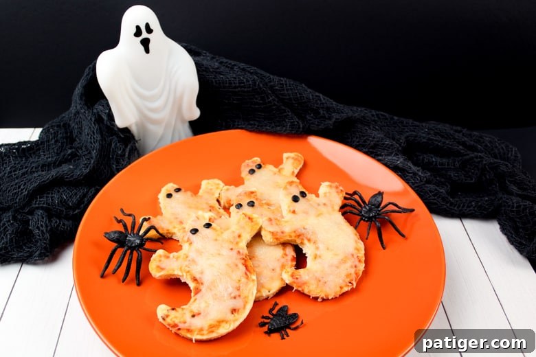 Phantom Pizza Bites 3 Mini Ghost Pizzas served on an orange plate.