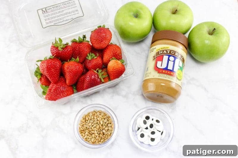 Strawberries, green apples, peanut butter, sunflower seeds, and candy eyes.