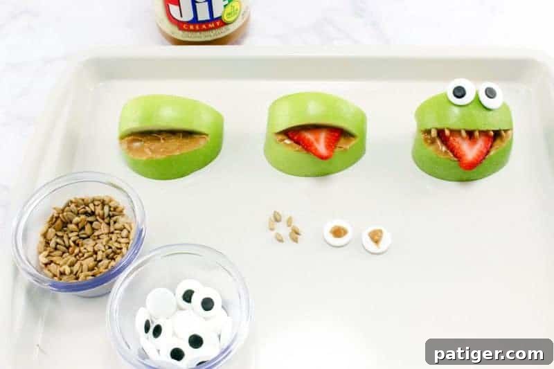 Apples on sheet pan being turned into monsters.