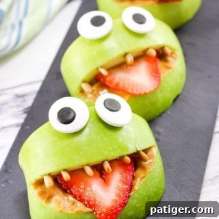 Made with apples, peanut butter, strawberries, sunflower seeds, and edible eyes, these Monster Apple Bites are a fun snack packed with nutrition!