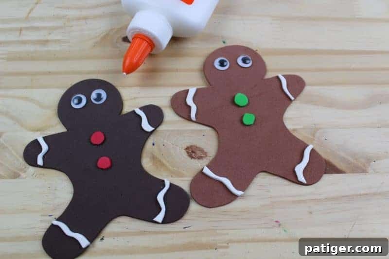 Fifth step: Carefully glue two googly eyes onto the head of each gingerbread man, instantly bringing them to life with a playful, animated touch.