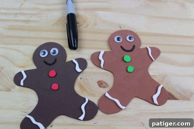 Sixth step: Use a black marker to add fine details like charming smiles, dots for noses, or decorative patterns to the gingerbread men, enhancing their character.