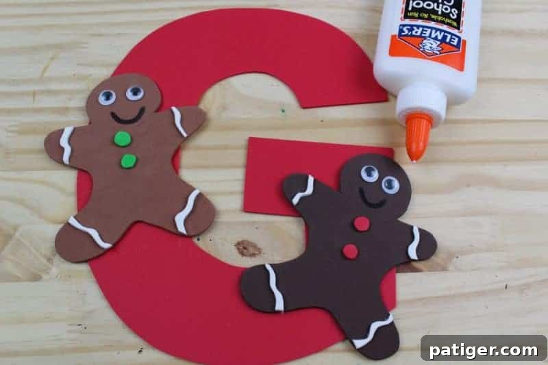 Seventh step: Glue the fully decorated gingerbread men onto the large craft foam letter G, carefully arranging them to complete the educational craft.