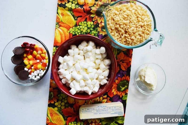 A selection of ingredients laid out on a wooden surface for making Rice Krispie Turkey Treats