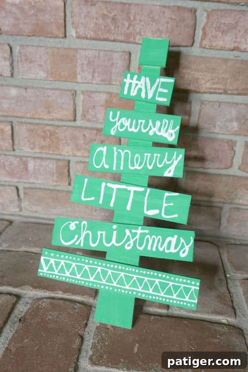 Create a unique DIY holiday phrase wooden Christmas tree for festive home decor. Easy craft project for personalized Christmas decorations.