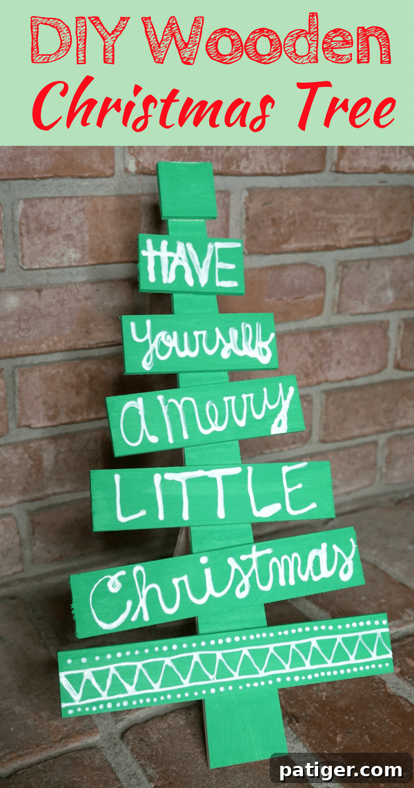 Beautifully hand-lettered DIY wooden Christmas tree with a festive holiday phrase, perfect for unique Christmas decorations.