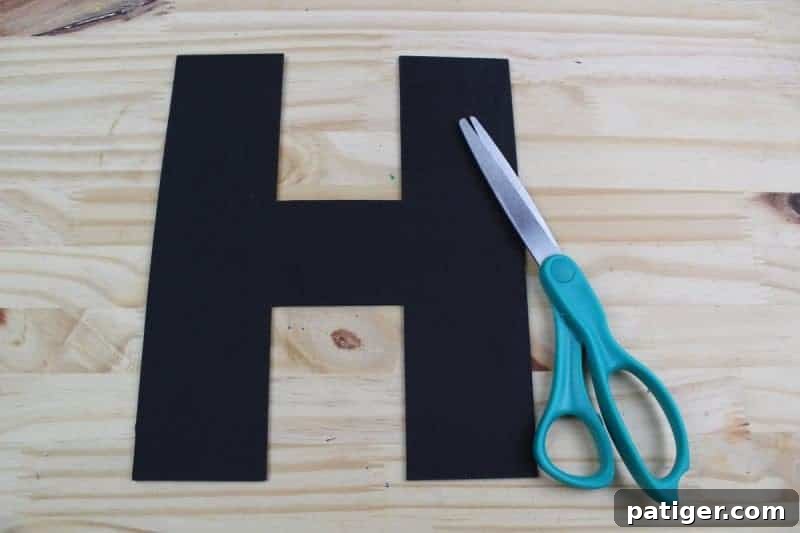 Next, carefully cut out the traced letter H from the craft foam, enhancing scissor skills and reinforcing the letter's shape.