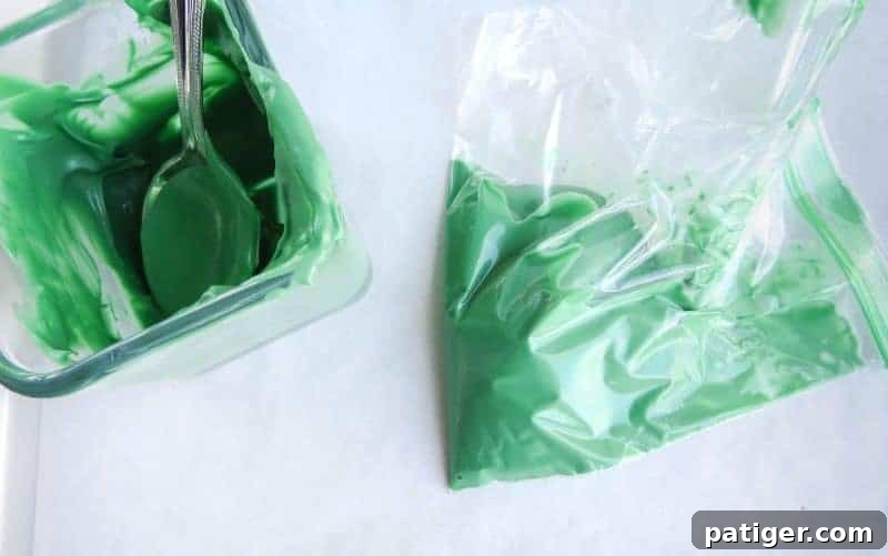Melted green candy melts in a piping bag, ready to form the Christmas trees.