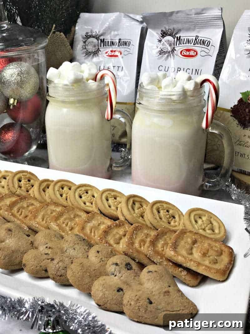 A mug of homemade white hot chocolate next to a plate of delicious Mulino Bianco cookies, highlighting a perfect sweet pairing for winter.