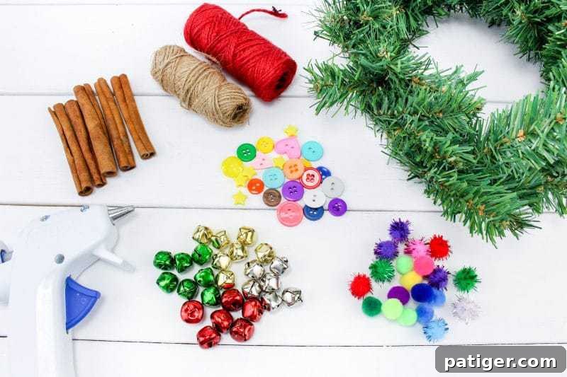 All the craft supplies laid out for the DIY Christmas Tree Ornament, including cinnamon sticks, garland, twine, buttons, pom poms, and jingle bells.